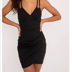 A body con dress that has straps on the back